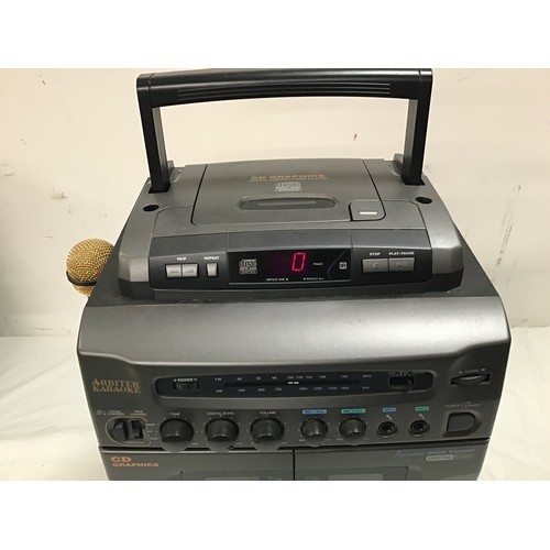 128 - KARAOKE MACHINE. This is made by Arbiter and plays cd and CDG discs. Powers up fine.. comes with 1 m... 