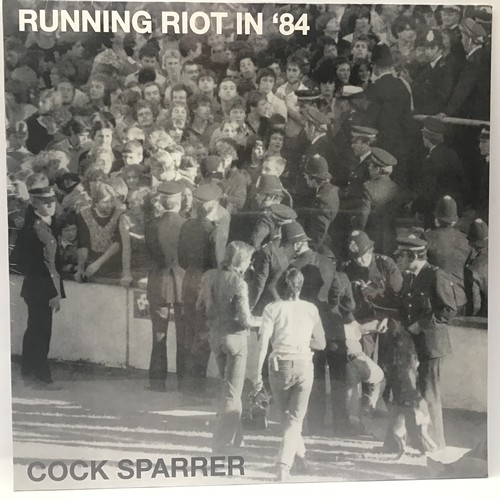 63 - COCK SPARRER LP RECORD 'RUNNING RIOT IN '84'. Re-issue still factory sealed on Santa Records.