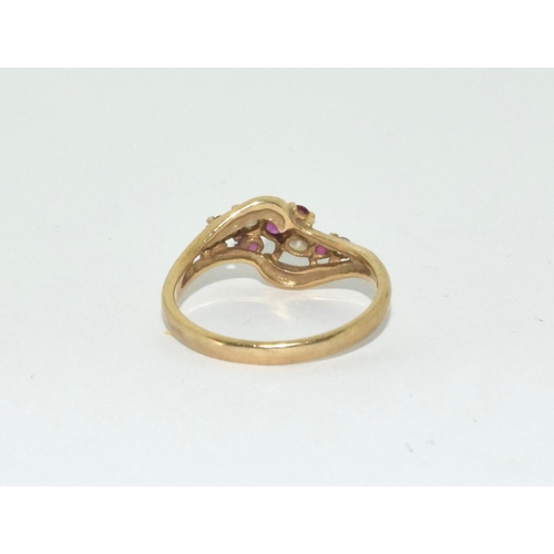 361 - 9ct gold ladies diamond and ruby twist ring size N