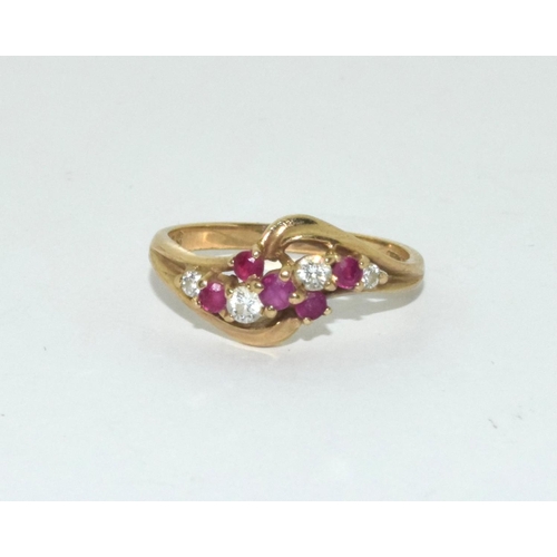 361 - 9ct gold ladies diamond and ruby twist ring size N