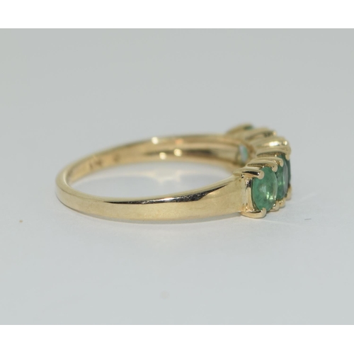 405 - A 9ct gold emerald five stone ring Size L