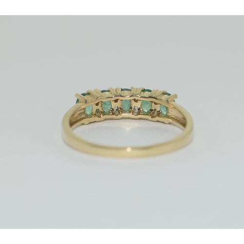 405 - A 9ct gold emerald five stone ring Size L