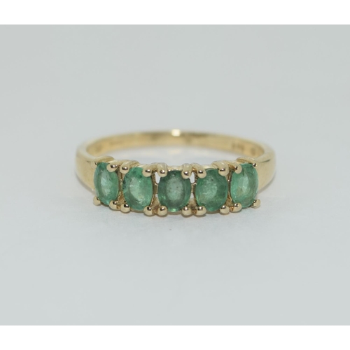 405 - A 9ct gold emerald five stone ring Size L