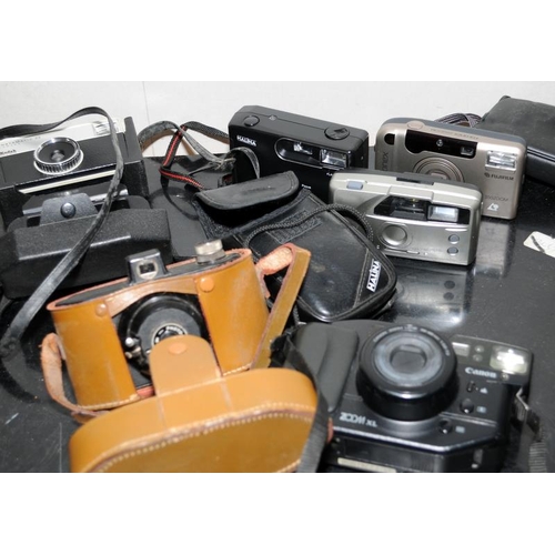 76 - Collection of vintage cameras to include an Olympus OM10 and a pair of vintage tinted goggles