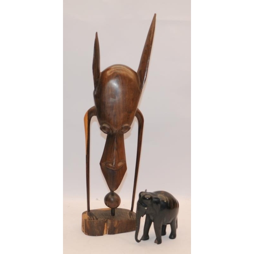 25 - Tribal art hardwood abstract figure c/w hardwood carved elephant. Figure 51cms tall