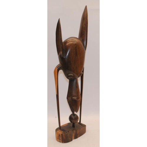 25 - Tribal art hardwood abstract figure c/w hardwood carved elephant. Figure 51cms tall