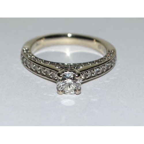 401 - A Diamond solitaire approx 0.50 point with diamond shoulders and diamond sides set in 14ct white gol... 