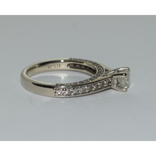 401 - A Diamond solitaire approx 0.50 point with diamond shoulders and diamond sides set in 14ct white gol... 