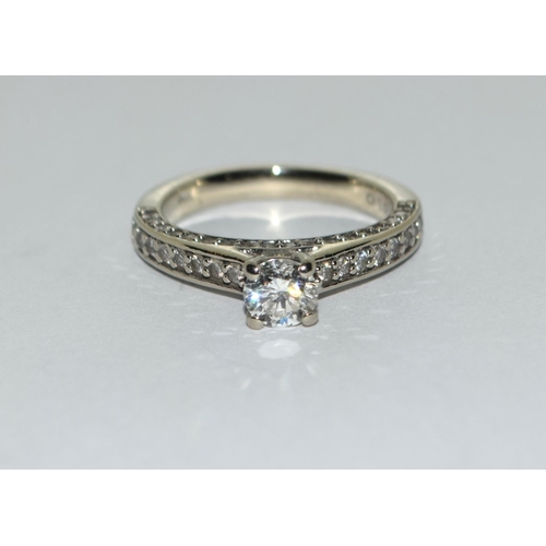 401 - A Diamond solitaire approx 0.50 point with diamond shoulders and diamond sides set in 14ct white gol... 