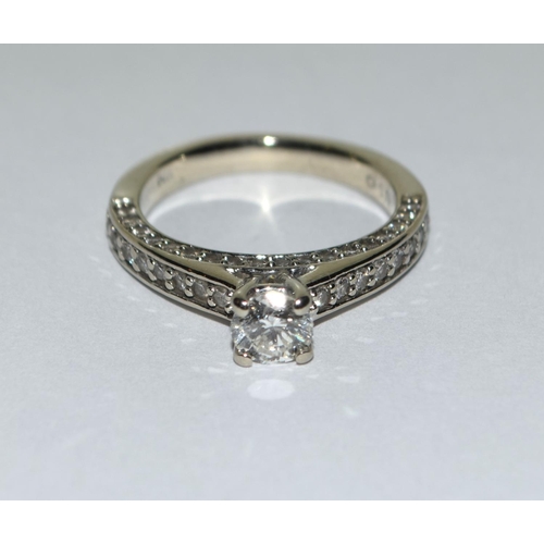 401 - A Diamond solitaire approx 0.50 point with diamond shoulders and diamond sides set in 14ct white gol... 