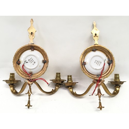 143 - A pair of decorative brass wall sconces with Meissen Limoges pictoral plaques together with a three ... 