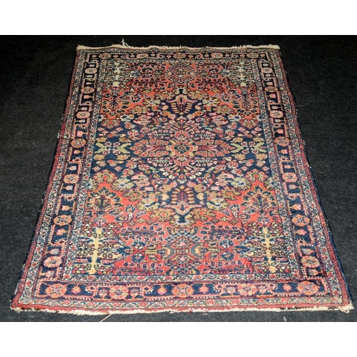 293 - Vintage hearth rug with age related wear. Mostky blues and reds on a cream ground. 150cms x 100cms