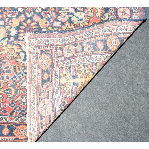 293 - Vintage hearth rug with age related wear. Mostky blues and reds on a cream ground. 150cms x 100cms