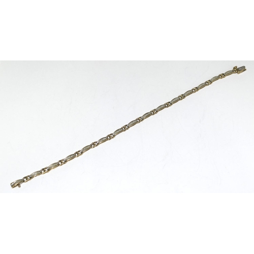 404 - 9ct gold ladies Diamond bracelet of approx 2ct set with bagget cut diamonds