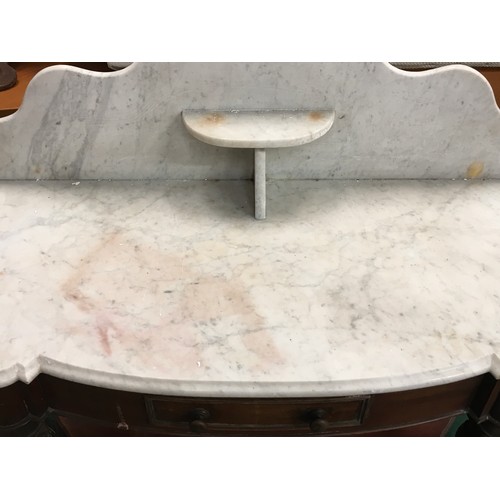 521 - A Victorian mahogany marble topped washstand with splash back on turned supports and drawer to centr... 