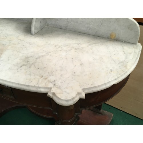 521 - A Victorian mahogany marble topped washstand with splash back on turned supports and drawer to centr... 