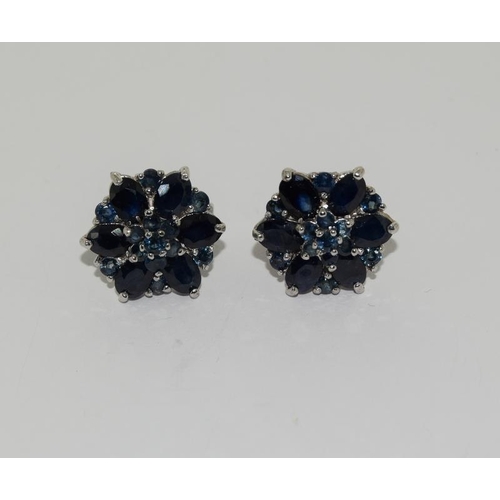 393 - White metal sapphire cluster earrings.