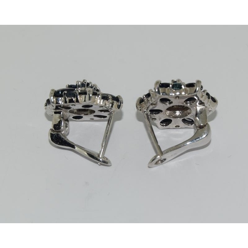 393 - White metal sapphire cluster earrings.