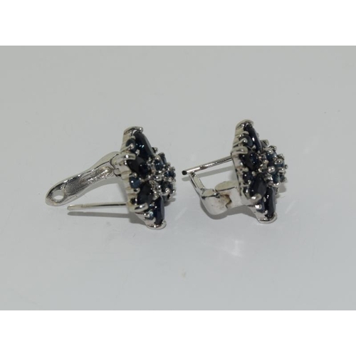 393 - White metal sapphire cluster earrings.