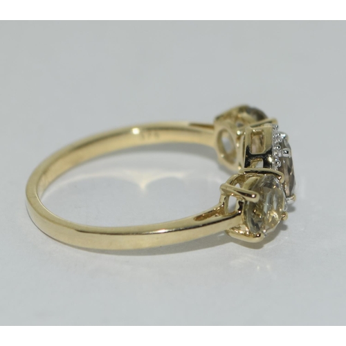 467 - A 9ct gold 3 stone green amethyst ring. Size N 1/2.