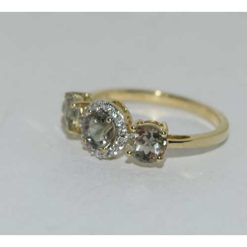 467 - A 9ct gold 3 stone green amethyst ring. Size N 1/2.