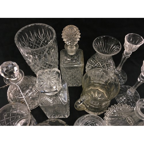 118 - Large collection of assorted crystal glassware to include decanters, vases and candlesticks.