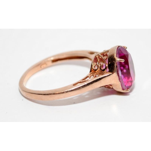 397 - A rose gold on 925 silver ring with pink stone to centre, Size P