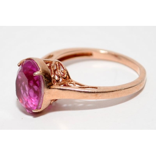 397 - A rose gold on 925 silver ring with pink stone to centre, Size P