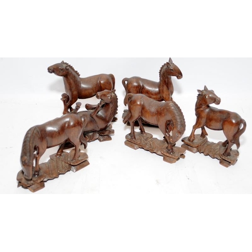 54 - Collection of small wooden carved horse figures together with a boxed set of wooden napkin rings and... 