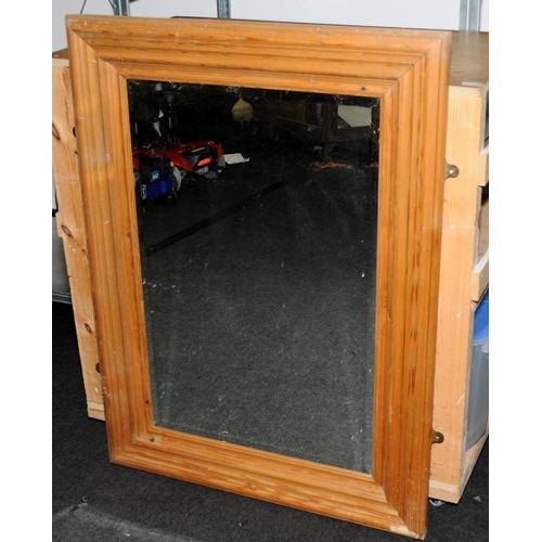 296 - Substantial bevelled edge mirror in a pine frame. O/all size 84cms x 112cms