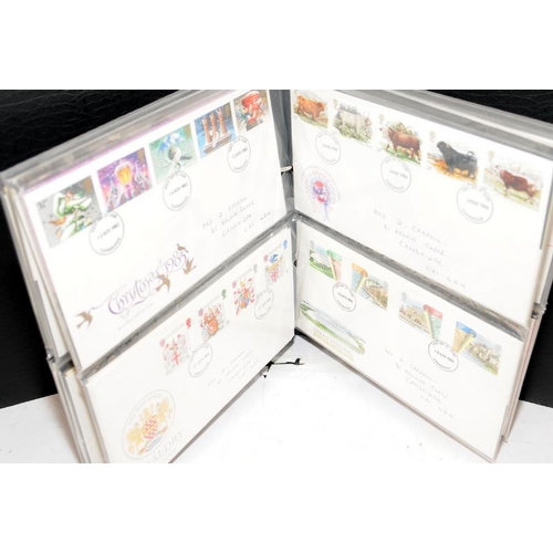 227 - A collection of first day covers contained within four albums together with a number of franked enve... 