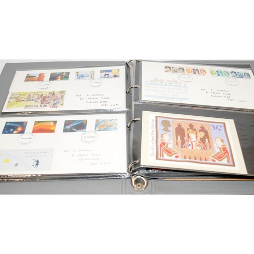 227 - A collection of first day covers contained within four albums together with a number of franked enve... 