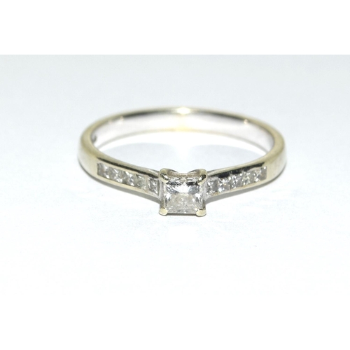 317 - A 9ct Gold and Diamond solitaire ring with diamond shoulders, Size M