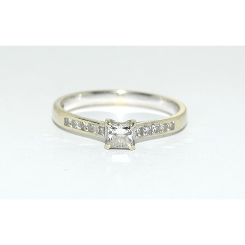 317 - A 9ct Gold and Diamond solitaire ring with diamond shoulders, Size M