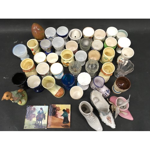 83 - Collection of porcelain and glass egg cups by various makers together with a 