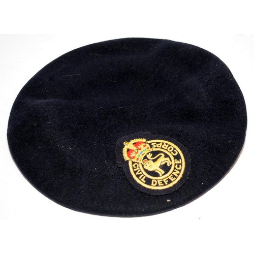 144 - Post war Cold War Civil Defence Corps beret and arm band c/w a King's Crown ARP badge