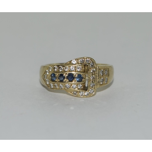 392 - An 18ct diamond and sapphire buckle ring. Size l