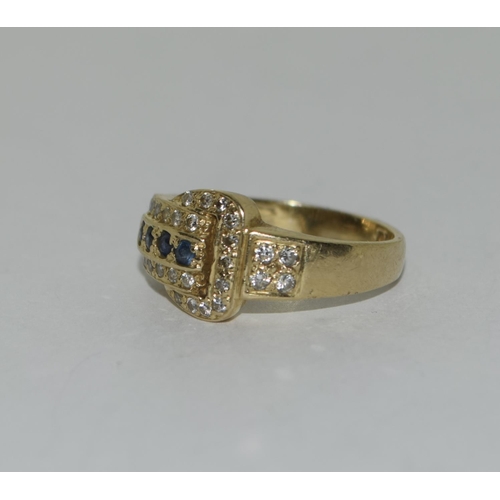 392 - An 18ct diamond and sapphire buckle ring. Size l