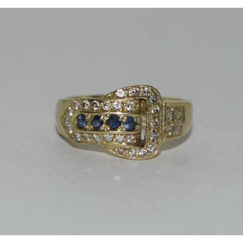 392 - An 18ct diamond and sapphire buckle ring. Size l