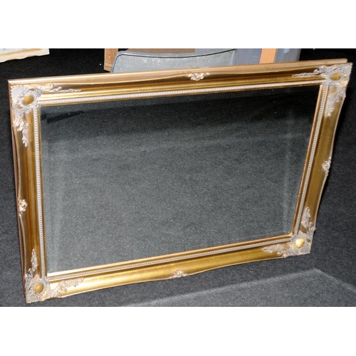 526 - Large bevelled edge mirror in ornate gilded frame. O/all frame size 106cms x 75cms