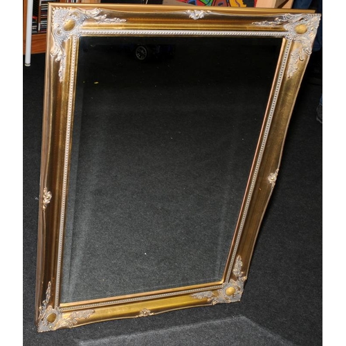 526 - Large bevelled edge mirror in ornate gilded frame. O/all frame size 106cms x 75cms