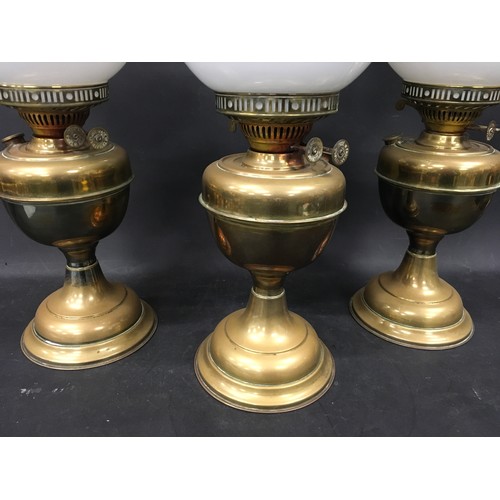 140 - Three vintage Duplex oil lamps each with glass chimney and opaline glass globe shade.