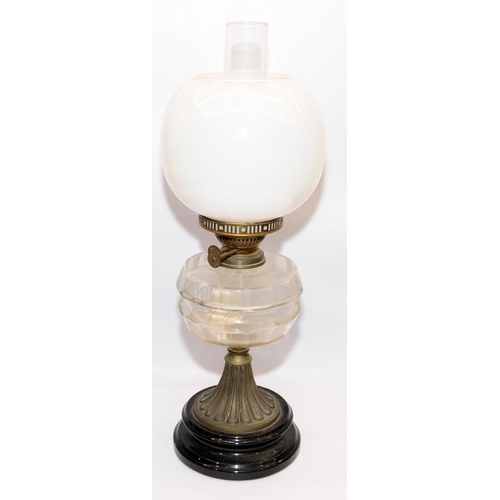 62 - Two antique oil lamps in excellent condition with clear glass reservoirs. Largest is 66cms tall