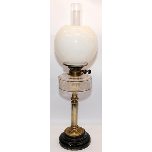 62 - Two antique oil lamps in excellent condition with clear glass reservoirs. Largest is 66cms tall