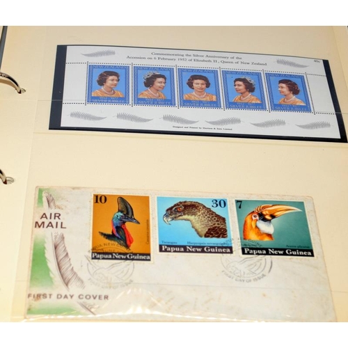 229 - Two stamp albums, one with world first day covers and the other dedicated to stamps of Papua New Gui... 