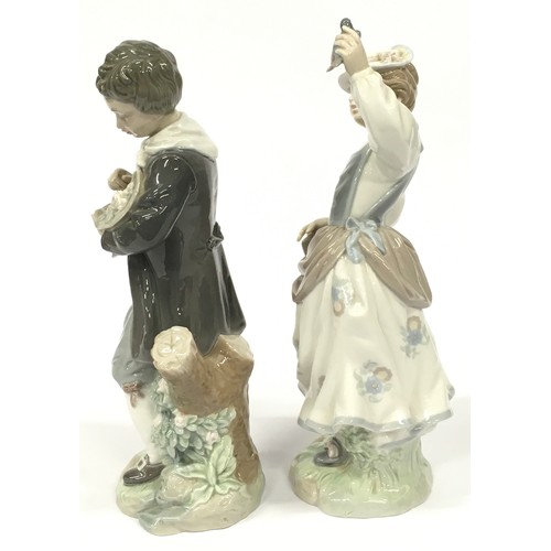 2 - Two Lladro figurines of a boy with flowers and a girl with a bird.