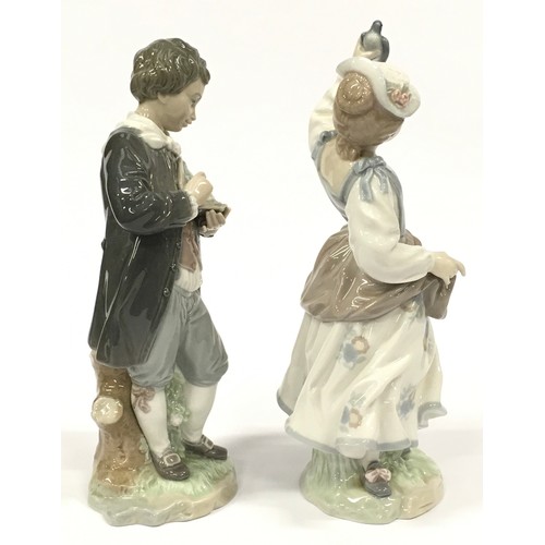 2 - Two Lladro figurines of a boy with flowers and a girl with a bird.