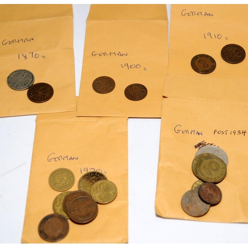 249 - Collection of world coins contained within a folder and a tin