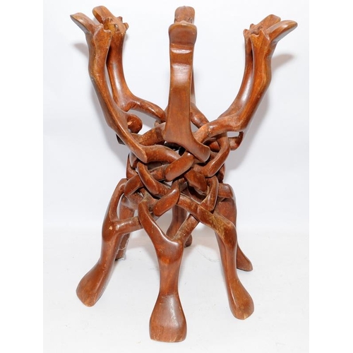 79 - Vintage carved wood camel stand with six interlocking legs carved from a single piece. With centre c... 