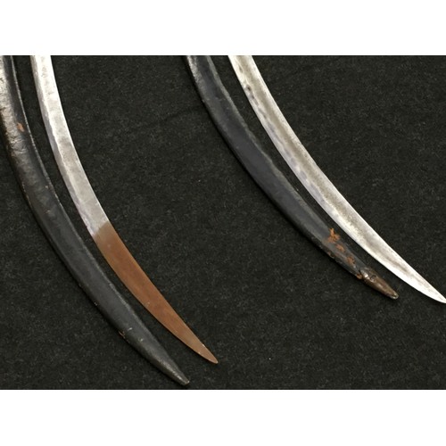 116 - Pair of antique swords with leather sheaths.